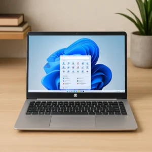 A sleek HP 14-inch laptop with a Windows 11 desktop interface on a wooden desk, surrounded by minimal decor and natural lighting.