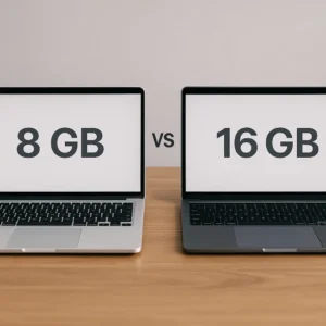 Two laptops placed side by side on a wooden desk, with one screen displaying "8 GB" and the other "16 GB", highlighting a comparison between different RAM capacities.